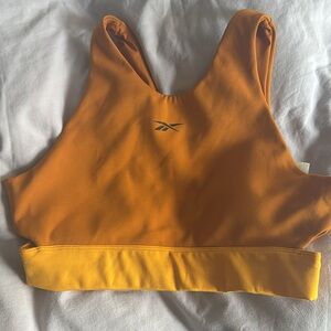 Reebok Beyond the Sweat Crop Top in Radiant Ochre